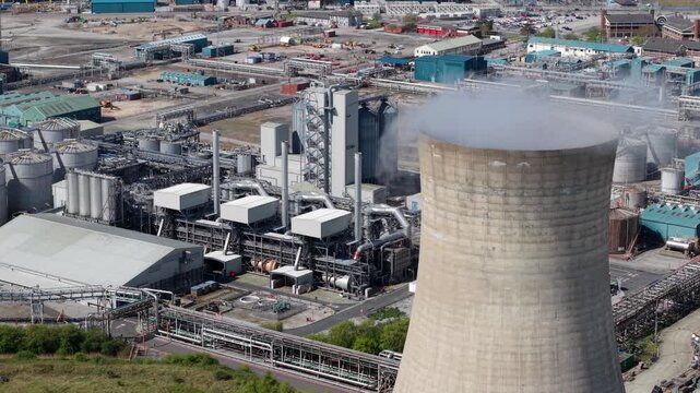 Close up aerial view of a concrete cooling tower with steam rising at Saltend Chemicals Park in Hull UK