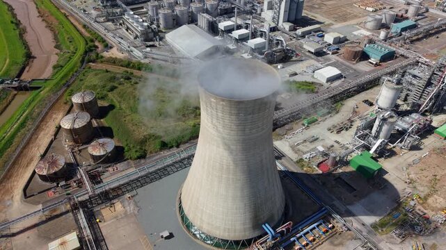 Close up aerial view of a concrete cooling tower with steam rising at Saltend Chemicals Park in Hull UK