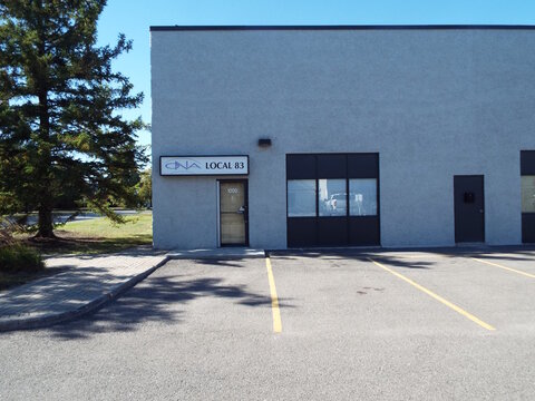 Nepean, Ontario, Canada &ndash; July 27, 2025: The "CNA Local 83" storefront sign is mounted on the gray exterior of this industrial building with a paved parking lot at 36 Antares Dr.