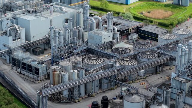 Aerial view of an industrial manufacturing factory with silos and piping on the banks of the River Aire UK