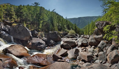 Russia, Western Buryatia, Eastern Sayan Mountains. A picturesque panorama of the Dabata mountain river rushing from the mountains at a 45-degree angle in countless cascades among huge boulders. © Александр Катаржин