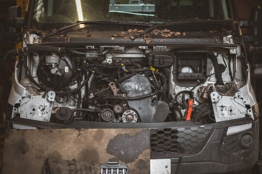 Vehicle engine compartment exposed for repair and maintenance work