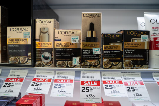 Close up of L'Oreal Paris skincare products on store shelf with sale labels. Toronto, Canada - April 19, 2026.