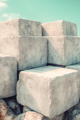 Fototapeta premium Concrete blocks stacked on a rocky shoreline, perfect for architecture or construction themed projects vertical frame