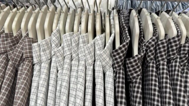 Plaid shirts on hangers in a store, showcasing fashion, retail theme, suitable as background
