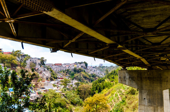 Perspective from the bottom of a bridge showing the density of urban settlements.