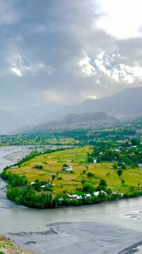 Ayun Valley in Chitral, Pakistan. Surrounded by majestic mountains, lush green fields, and charming traditional houses, Ayun serves as the gateway to the famous Kalash Valleys.