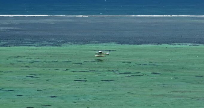 Aerial view of hydroplane is taking off or landing on a crystal clean water. Mauritius