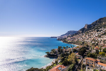 Fototapeta premium Mediterranean coastal city with turquoise sea under blue sky