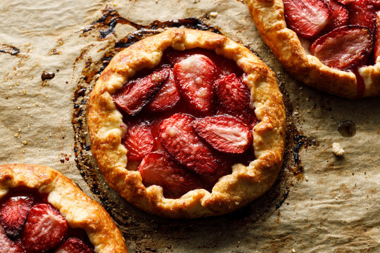 Strawberry galette on gray baking paper, top view