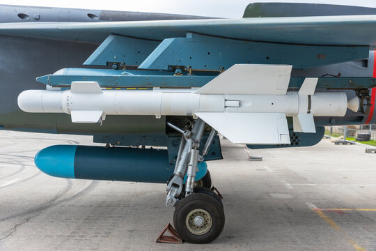 Close-up of old, unmaintained Cold War-era aircraft with mounted missile, highlighting vintage military technology and global arms trade concept
