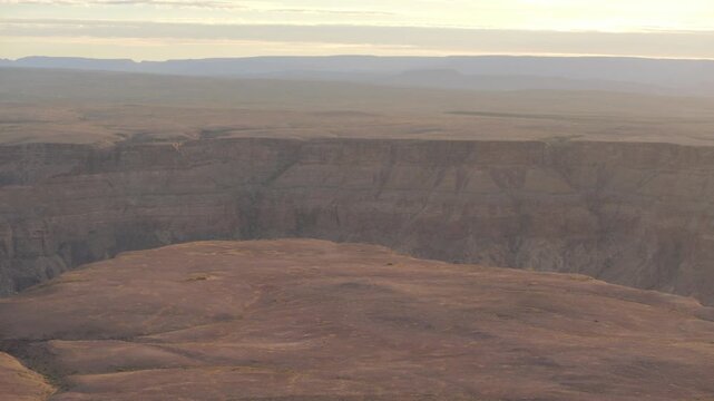 Rugged cliffs line the edges of Fish River Canyon in Namibia at sunset