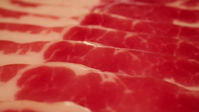  Sliced ham jamon fat bacon meat, beef pastrami thick pieces on a wooden board, beef or pork jamon. Chef cooking breakfast, smoked bacon in cafe. 