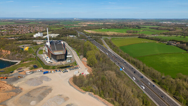 Aerial view of the Encyclis Newhurst ERF facility and the M1 motorway passing through the green countryside in Shepshed, England, United Kingdom.