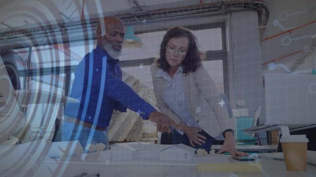 Designers reviewing plans for signoff HUD popping man pointing woman studying tablet code animating
