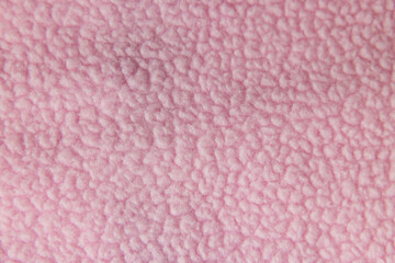 Macro texture of soft pink fleece or faux fur fabric © Ruslan