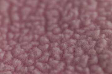 Macro texture of soft pink fleece or faux fur fabric © Ruslan
