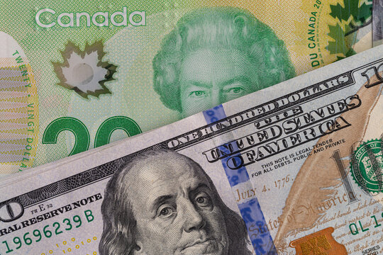 US hundred dollar bill and Canadian twenty dollar banknote close up