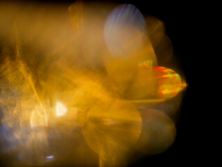Golden light dances against black void. Flickering trails suggest motion, energy, and mystery. Warm glow pulses through abstract forms. Ideal for dynamic backgrounds or creative textures