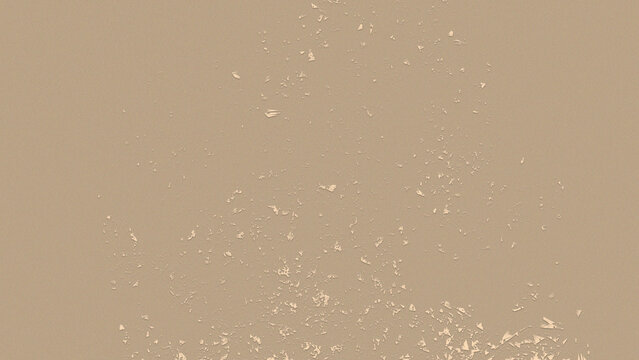 Small sharp beige paper fragments scattered across a flat surface creating a textured artistic design pattern