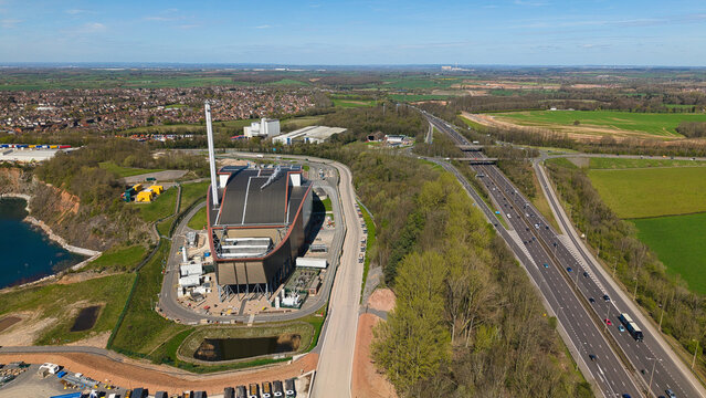 Aerial view of the Encyclis Newhurst ERF energy recovery facility and the M1 motorway surrounded by green fields in Shepshed, England, United Kingdom.