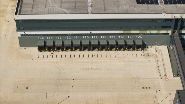 Aerial view of a supermarket distribution centre featuring numbered loading bays and a large concrete yard in Nailstone, Nuneaton, United Kingdom.