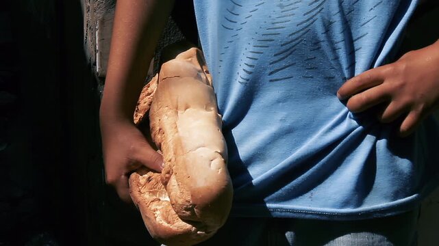 Close Up of Child Hands Holding Large Loaf of Homemade Bread - 4K