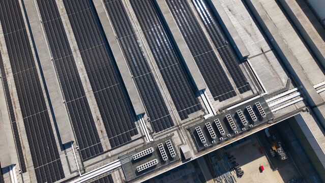 Aerial view of the Supermarket distribution Centre featuring vast solar panel arrays and cooling units on the roof in Nailstone, Nuneaton, United Kingdom.