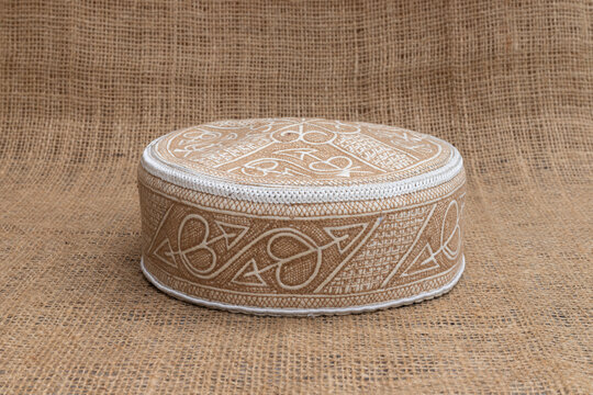 Pakistan Cultural Handmade Cap on Burlap Background