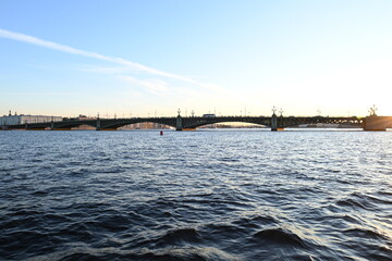 Fototapeta premium The beautiful water surface of the Neva river with bridges in St. Petersburg on an autumn evening