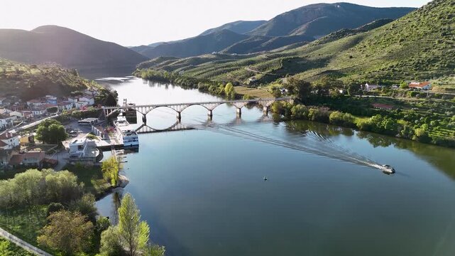 Scenic aerial view of a boat on douro river with bridge