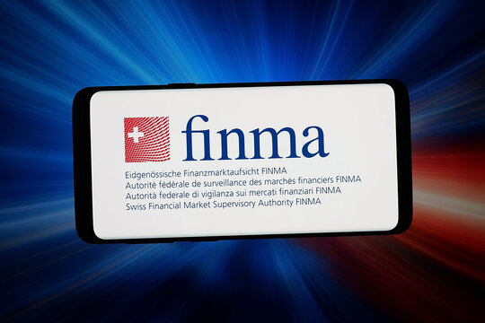 Stuttgart, Germany - 04-10-2026: In this photo illustration, the logo of Swiss financial market authority FINMA is displayed on a smartphone in front of abstract background on computer screen.