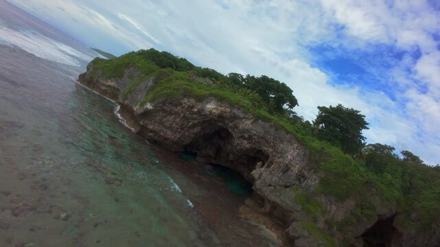 FPV Drone Flying Over Volcanic Coast and Waves in Niue