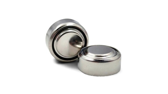 Photo of two small lithium coin cell (button cell) batteries commonly used in watches and electronic devices, isolated on a white background.