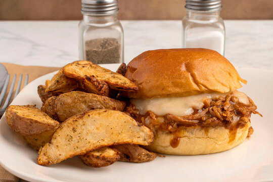 pulled pork sandwich with potato wedges