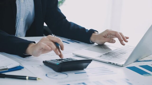 Two business people talk project strategy at office meeting room. Businessman discuss project planning with colleague at modern workplace while having conversation and advice on financial data report.