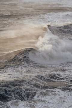 Dynamic ocean waves with natural photographic style on a coastal backdrop, concept of power and nature energy. Nazar&eacute;, Portugal 