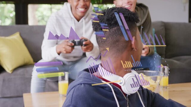 Three teen boys gaming in lounge, front teen tapping phone, charts popping up, friends cheering win