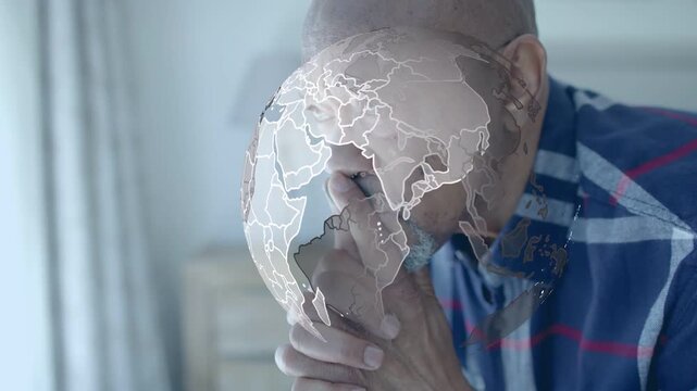 Senior man leaning, frames advancing rotating globe overlaying face and hands, showing tech focus