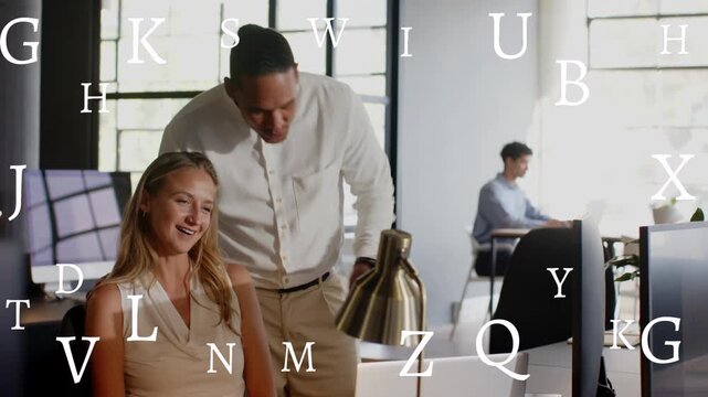 Man walking up leaning over seated woman pointing laptop in office while type overlaying, reviewing