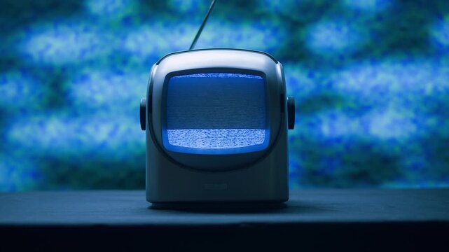 Retro TV, vintage television In a nostalgic setup, a retro TV displays grain on screen, scary halloween night device good for chroma key and green screen.