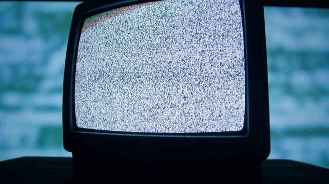 Retro TV, vintage television In a nostalgic setup, a retro TV displays grain on screen, scary halloween night device good for chroma key and green screen.