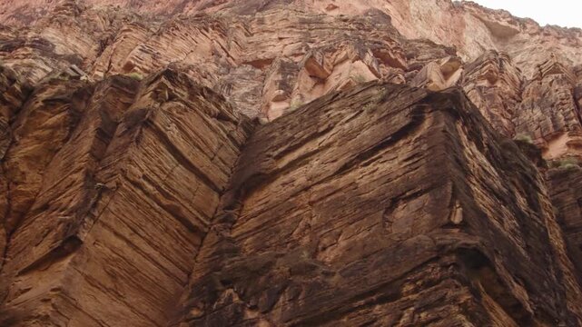 Massive red rock formations with visible sedimentary layers creating a stunning natural background