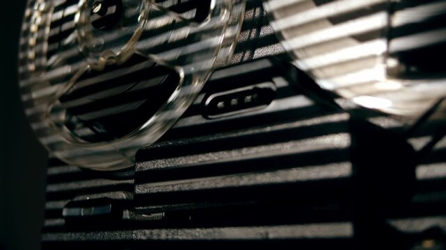 Tape audio music player, VHS studio magnetic tape, vintage retro spool reel to reel player and recorder, magnetic tape data storage close up, music studio. 