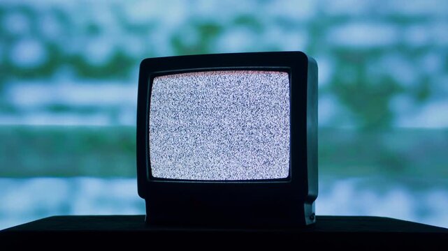 Retro TV, vintage television In a nostalgic setup, a retro TV displays grain on screen, scary halloween night device good for chroma key and green screen.