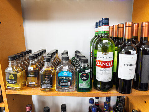 Argentina, El Chalten, March 05, 2026, Gancia, glass bottle, 1,25 l, and various alcoholic beverages including wine, vodka, and whisky on a wooden shelf in a local store.