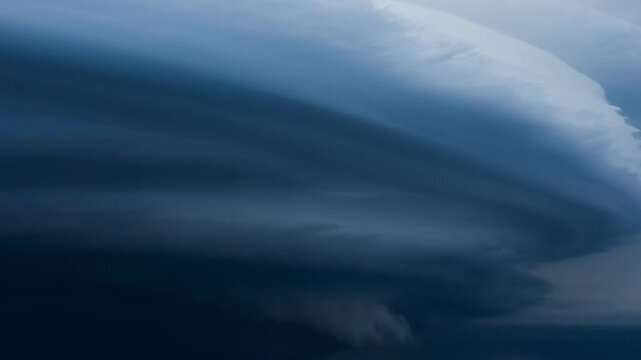 Ominous and threatening supercell thunderstorm developing in a dark and moody sky