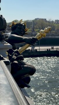 Bright sky highlights riverside scene with boats and statue