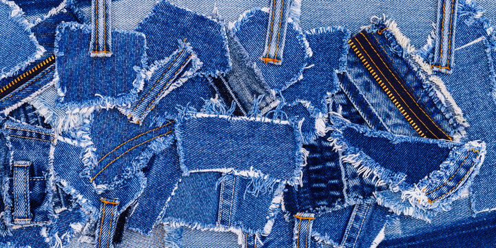 Various pieces of denim fabric arranged together on a flat surface for crafting or design activities