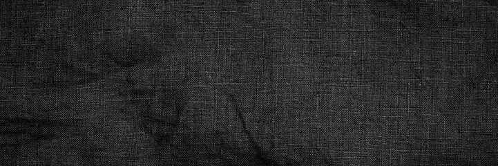 Fototapeta premium Fabric with dark texture laid flat on a surface